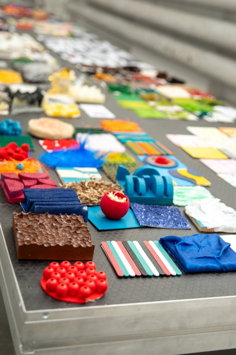 Colorful fabric and material samples on a table.