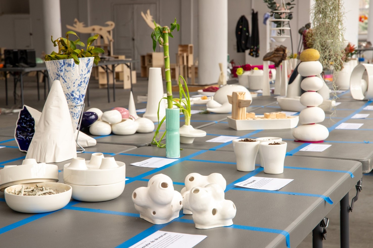 Pottery products arranged on a table - presentation of students' work.