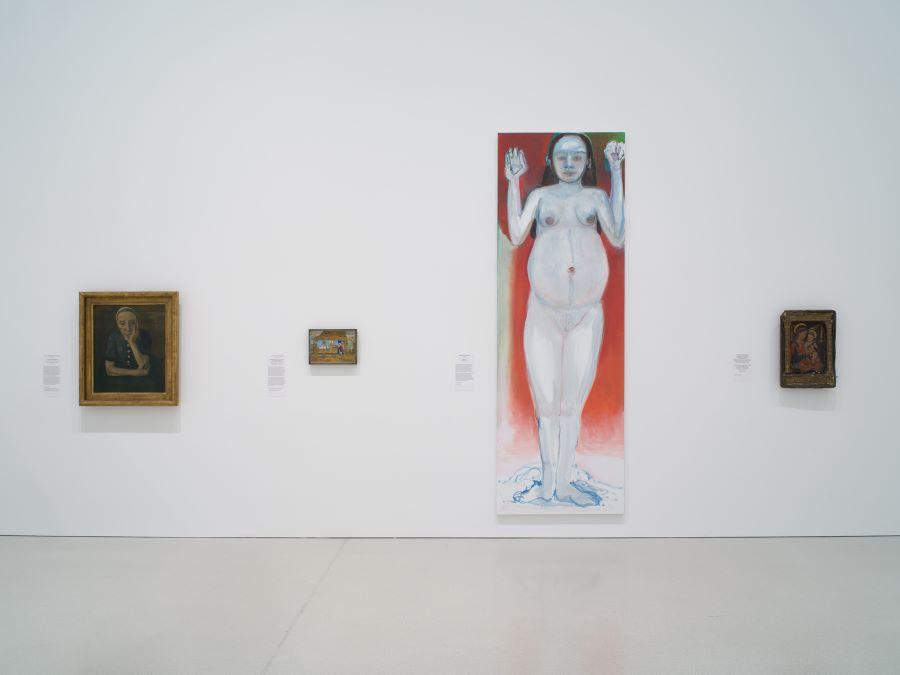 Four paintingd hanging on a wall in the museum