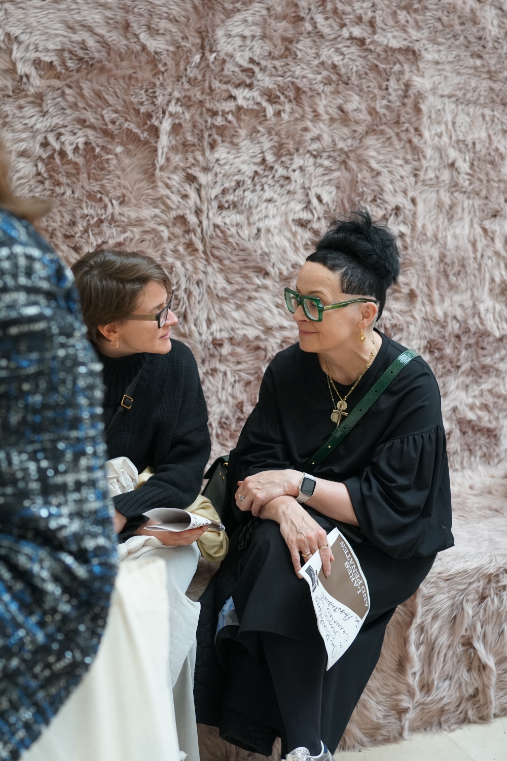 Two women talking during the opening of the “Lares and Penates” exhibition