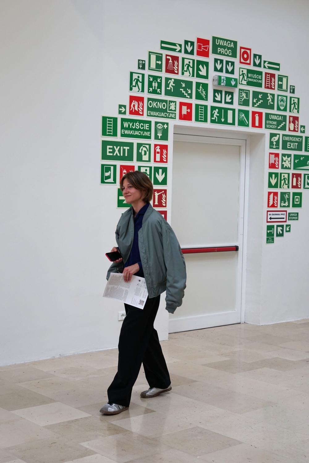 Woman exploring the “Lares and Penates” exhibition