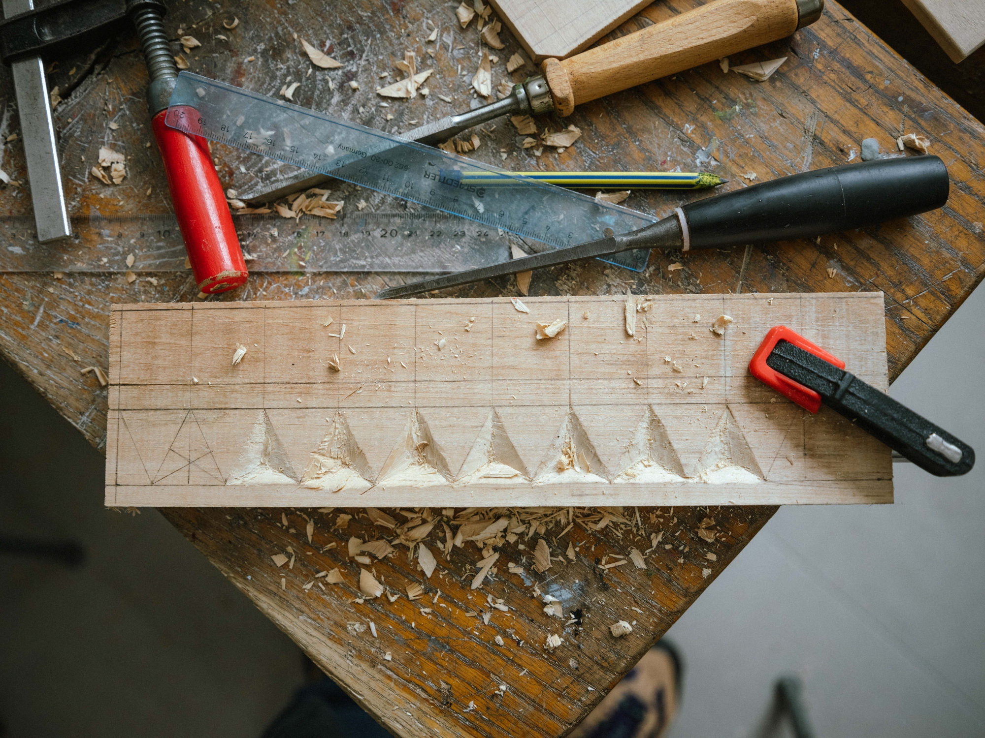 Wooden board with cut-out triangular ornaments