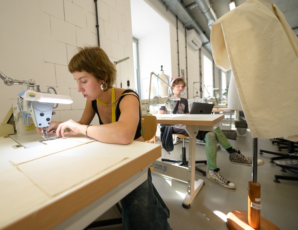 Sewing workshop. A girl is sewing on a sewing machine.