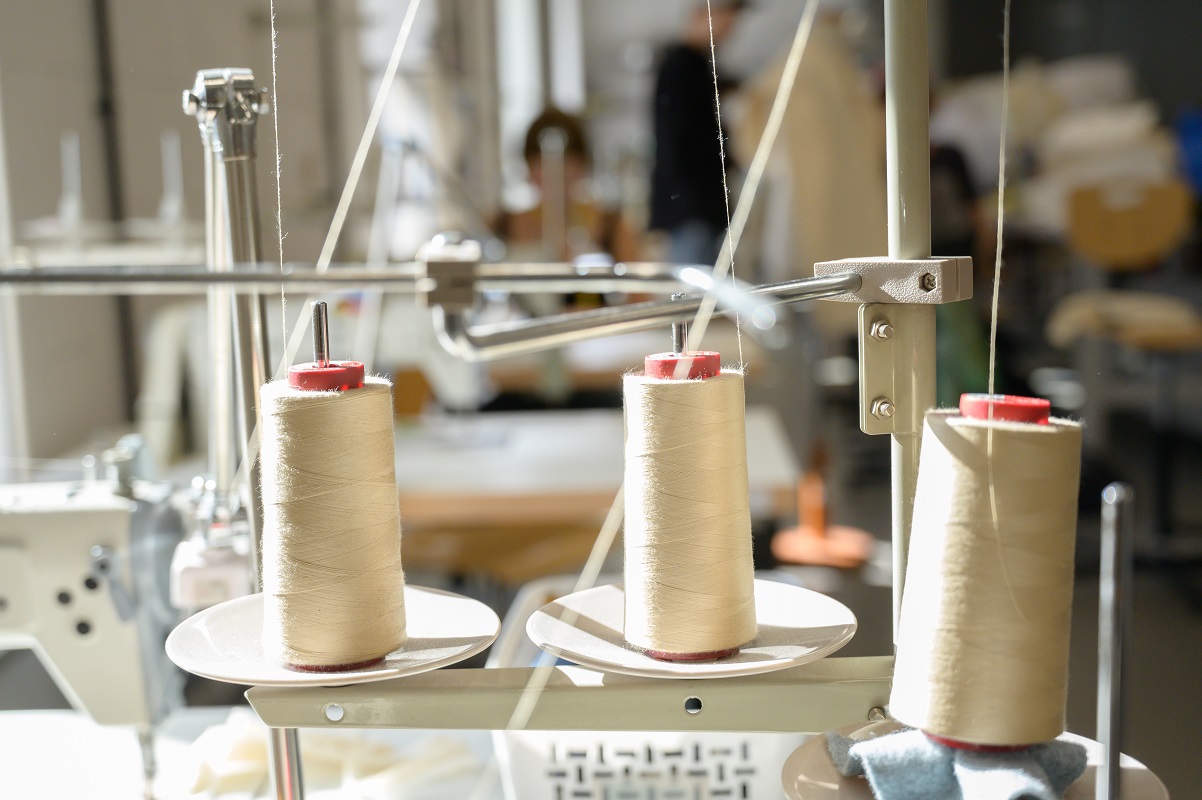 Close-up of sewing thread on large spools