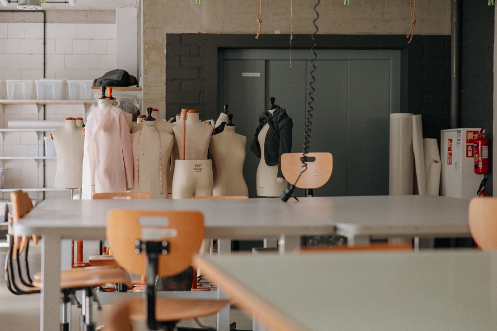 Sewing Workshop with worktables and mannequins in the background