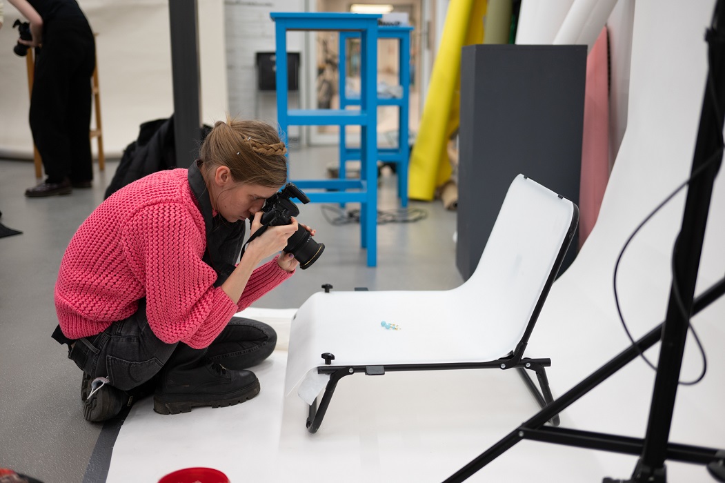 A girl takes a macro photo of a small object