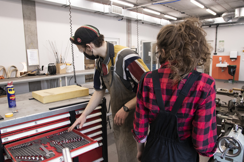 Man selects tools at Metal Workshop