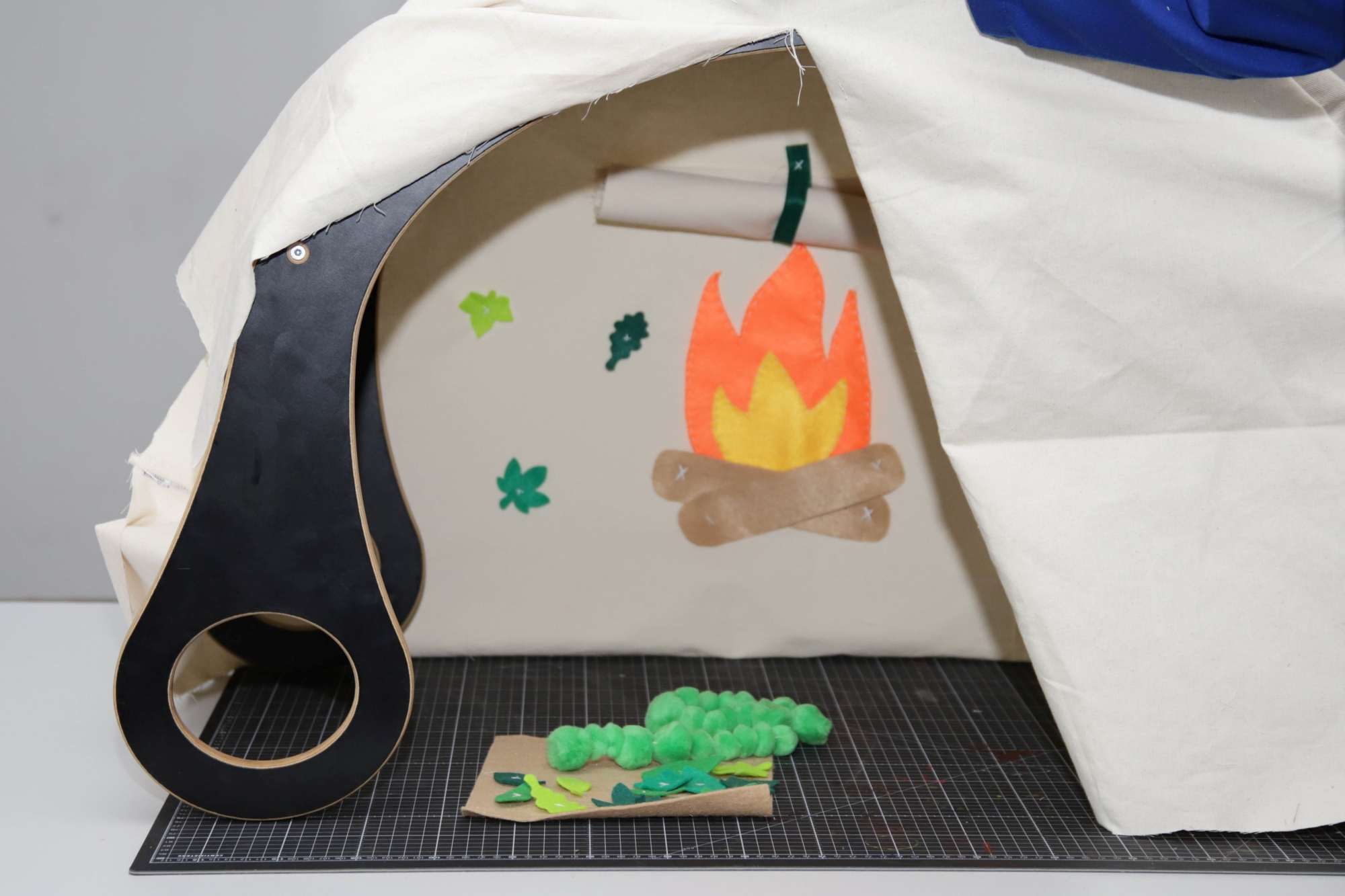 The inside of a rocker transformed into a tent with added accessories.