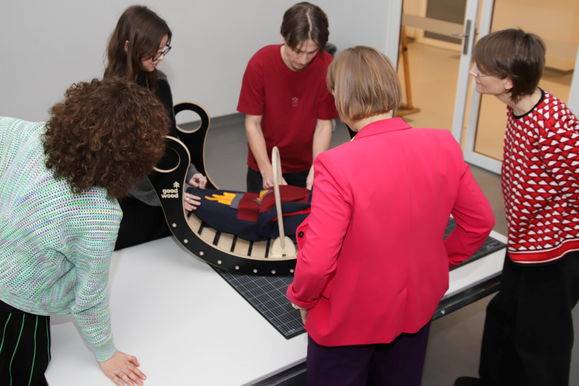 A group of students attaching accessories to a rocker.
