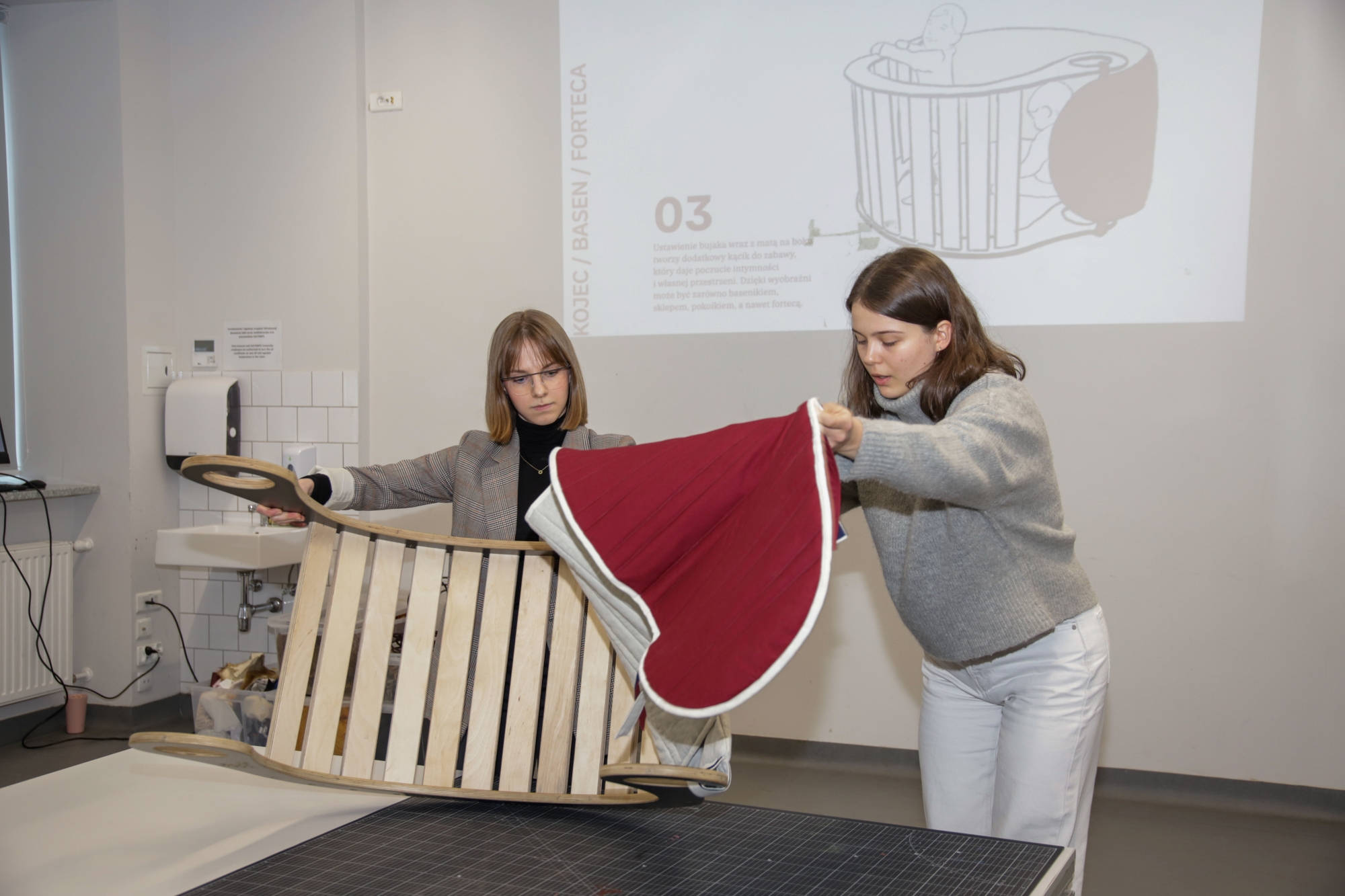 Students presenting their quilted mat designed for the rocker.