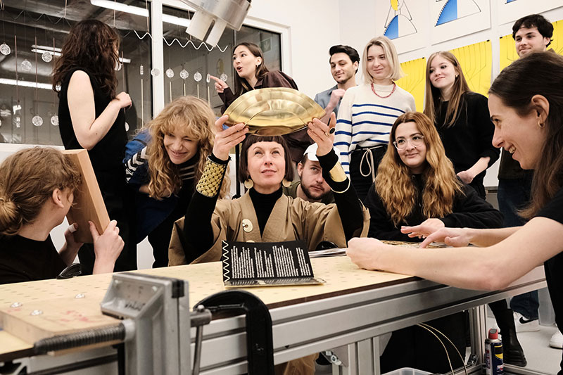 Anna Orska surrounded by students, holding Ritual Bowl