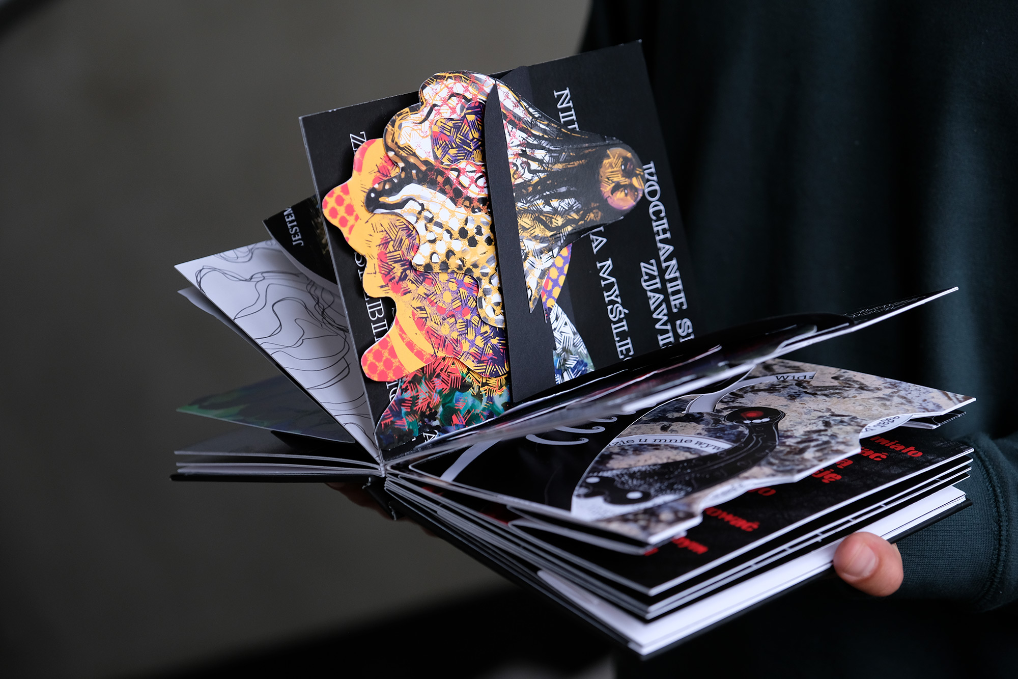 Open book with colorful illustrations inside, including 3D illustrations