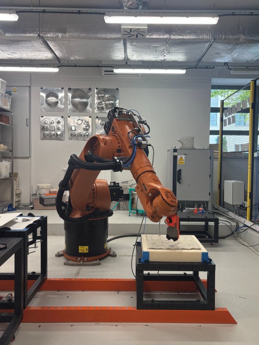 A KUKA robot felting the fabric.