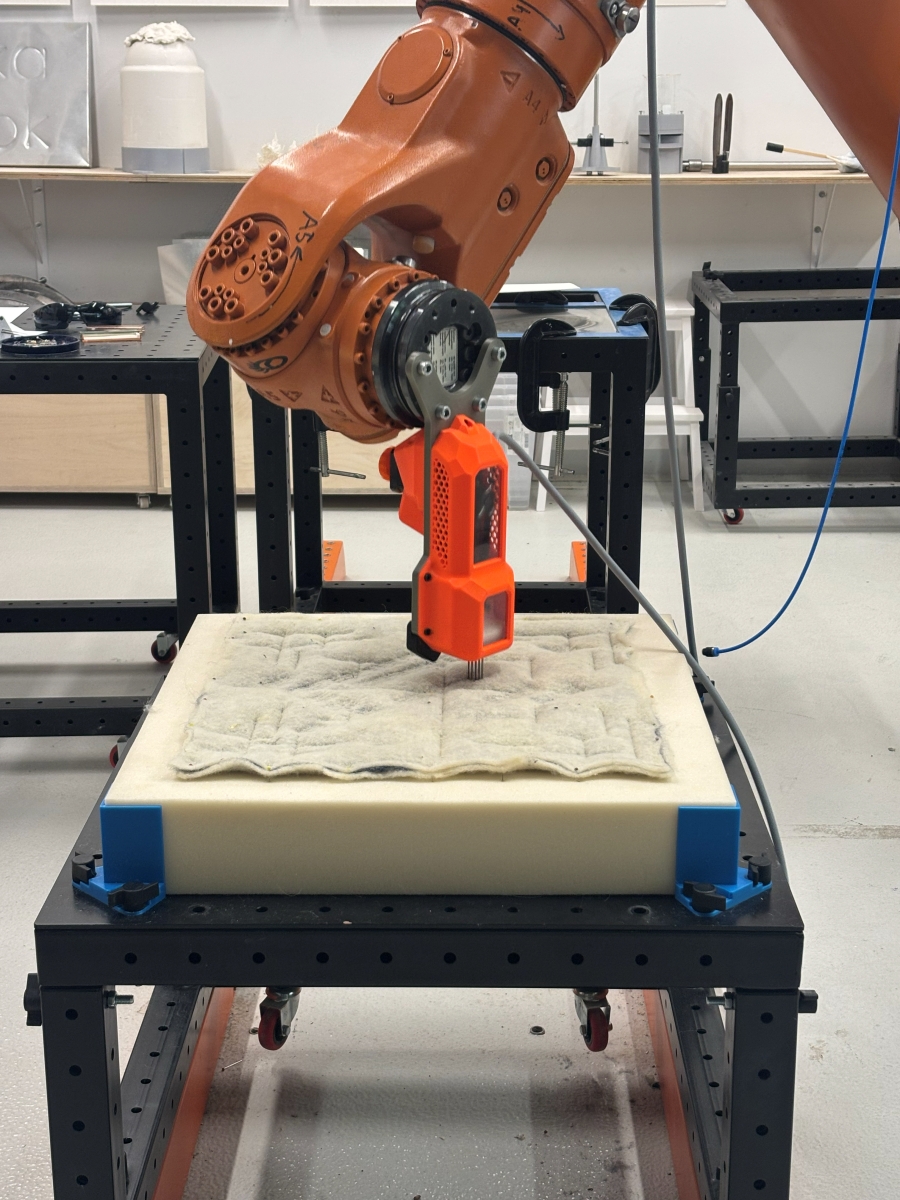 Close-up of an industrial robot felting the fabric.